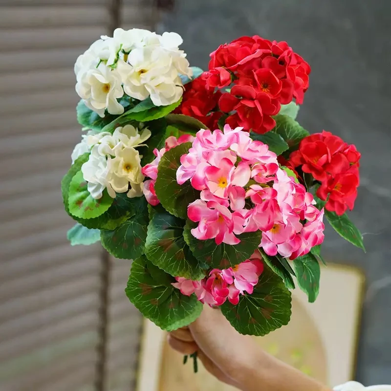 Pink, red and white artificial geranium flower bushes held together