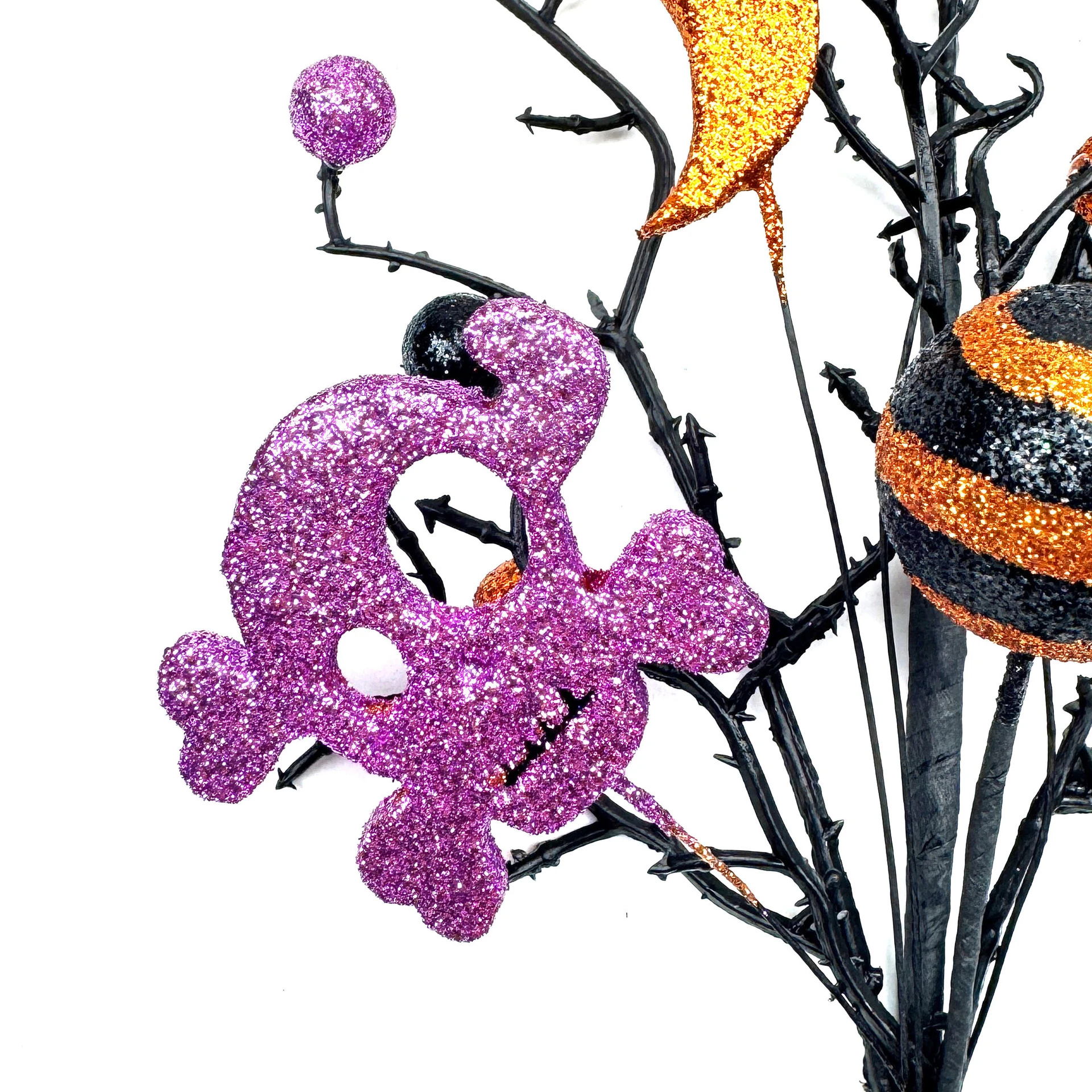 Close-up of detail artificial halloween bat skull pumpkin pick