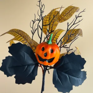 Close-up of jack o lantern black leaves artificial halloween pumpkin and black rose pick collection