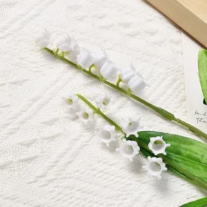 Close-up of white bell-shaped flowers on an artificial lily of the valley stem