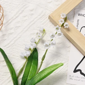 Two white artificial lily of the valley flowering branches