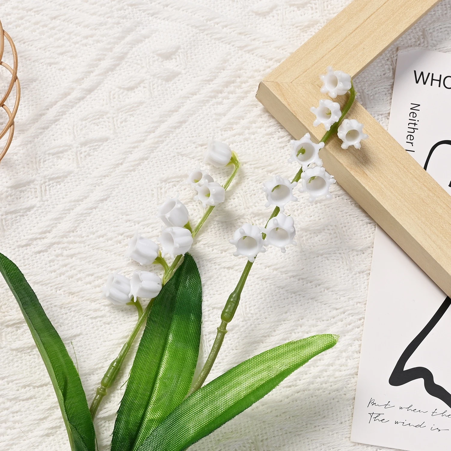 Two white artificial lily of the valley flowering branches