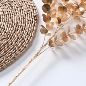 Close-up of round gold leaves on an artificial metallic eucalyptus spray