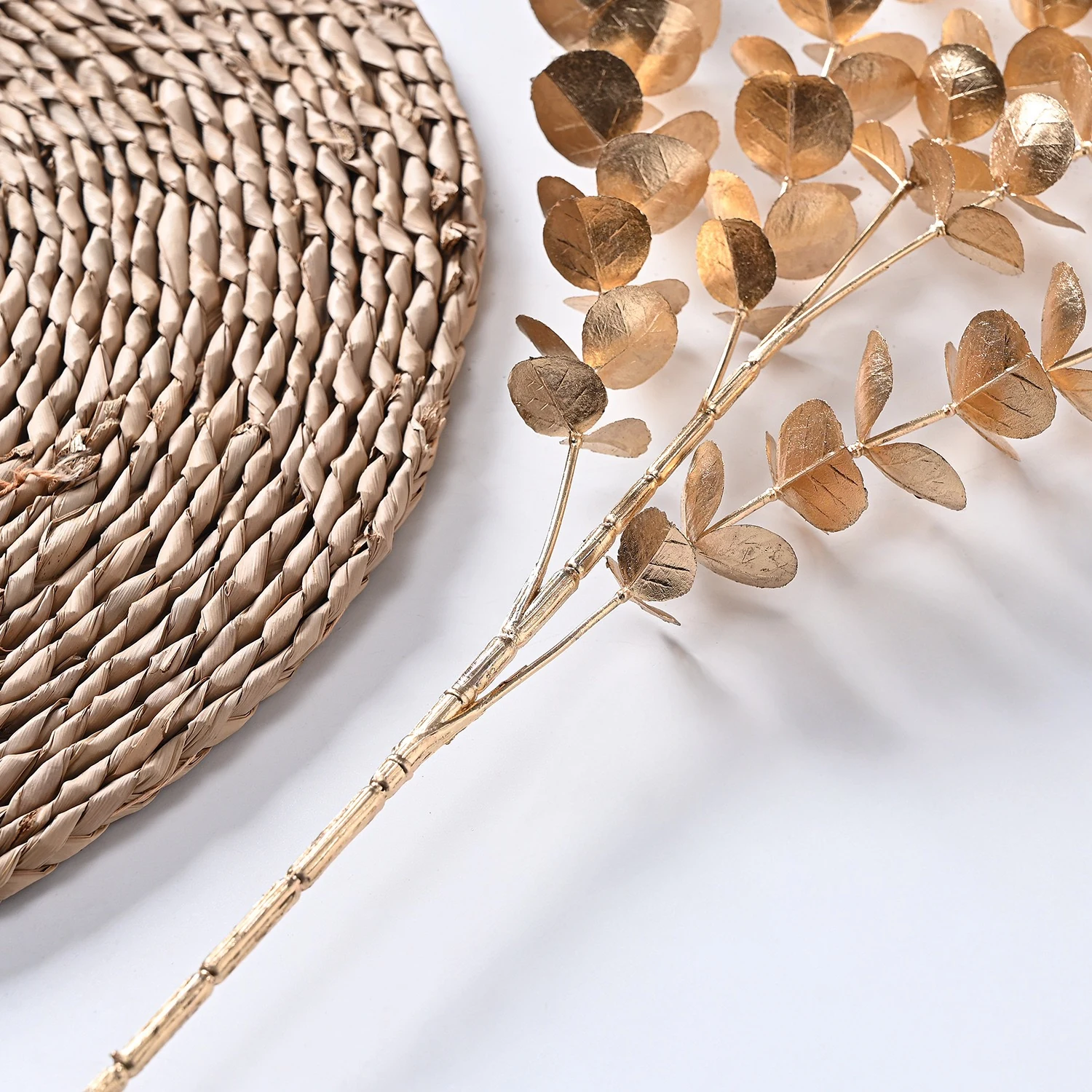 Close-up of round gold leaves on an artificial metallic eucalyptus spray
