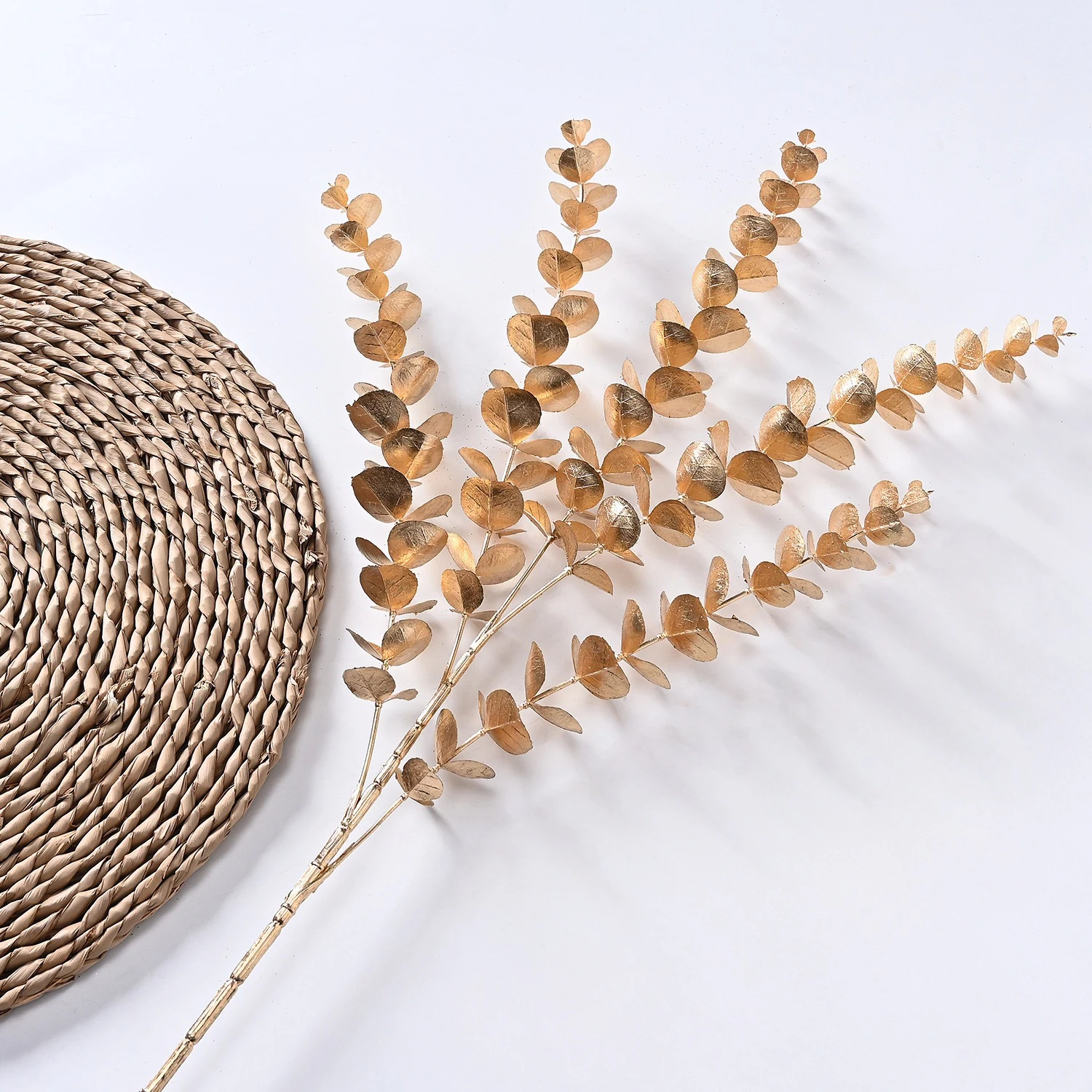 Gold artificial metallic eucalyptus spray in a styled flat-lay display