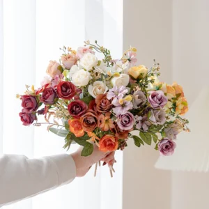 Handheld view of artificial mini rose mixed flower bouquet