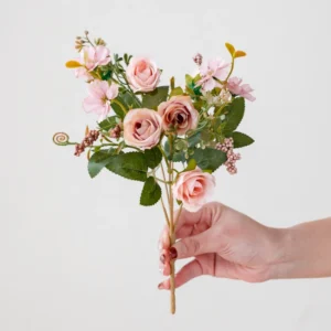 Handheld view of blush pink artificial mini rose mixed flower bouquet