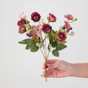 Handheld view of burgundy artificial mini rose mixed flower bouquet
