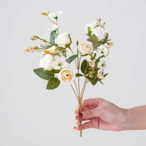 Handheld view of white artificial mini rose mixed flower bouquet
