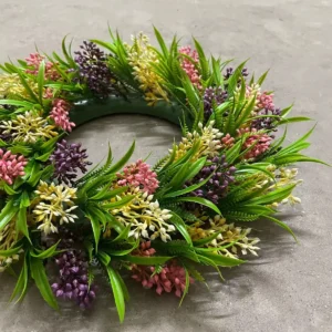 Angled view of artificial mixed greenery wreath