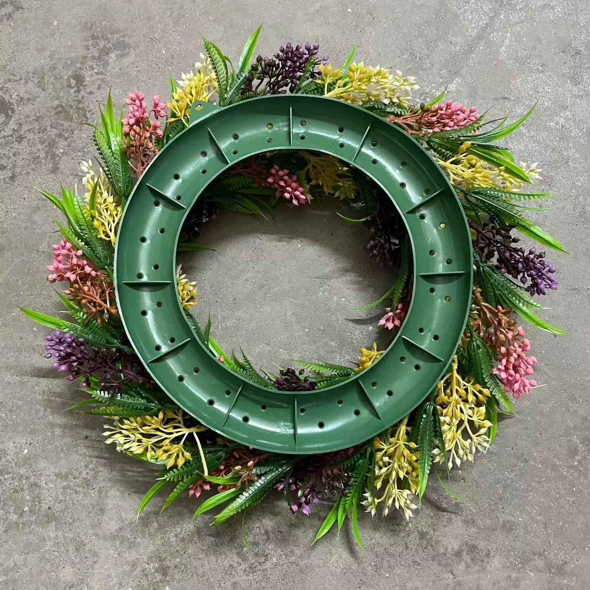 Back base detail of artificial mixed greenery wreath