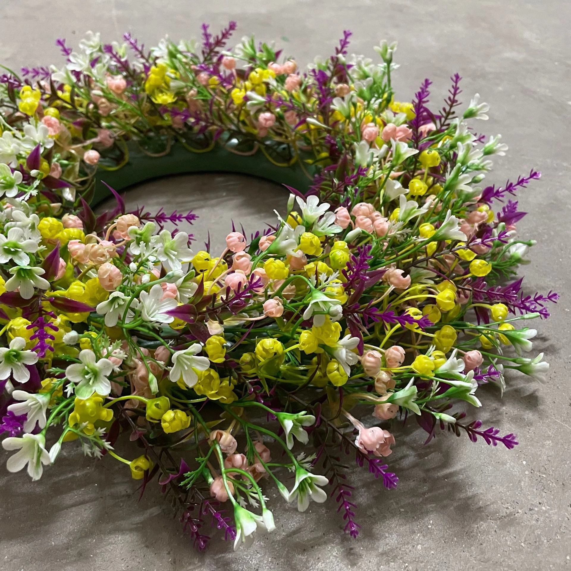 Close-up of pastel artificial mixed wildflower wreath collection