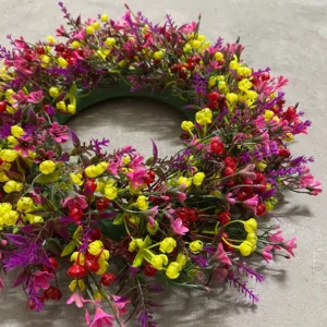 Close-up of purple yellow artificial mixed wildflower wreath collection