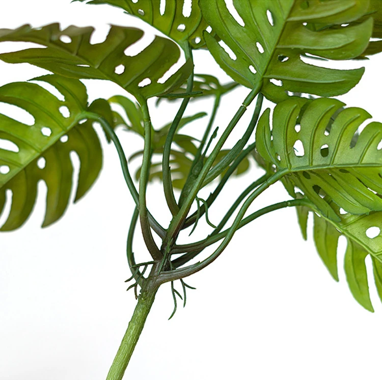 Close-up of artificial monstera leaf bush
