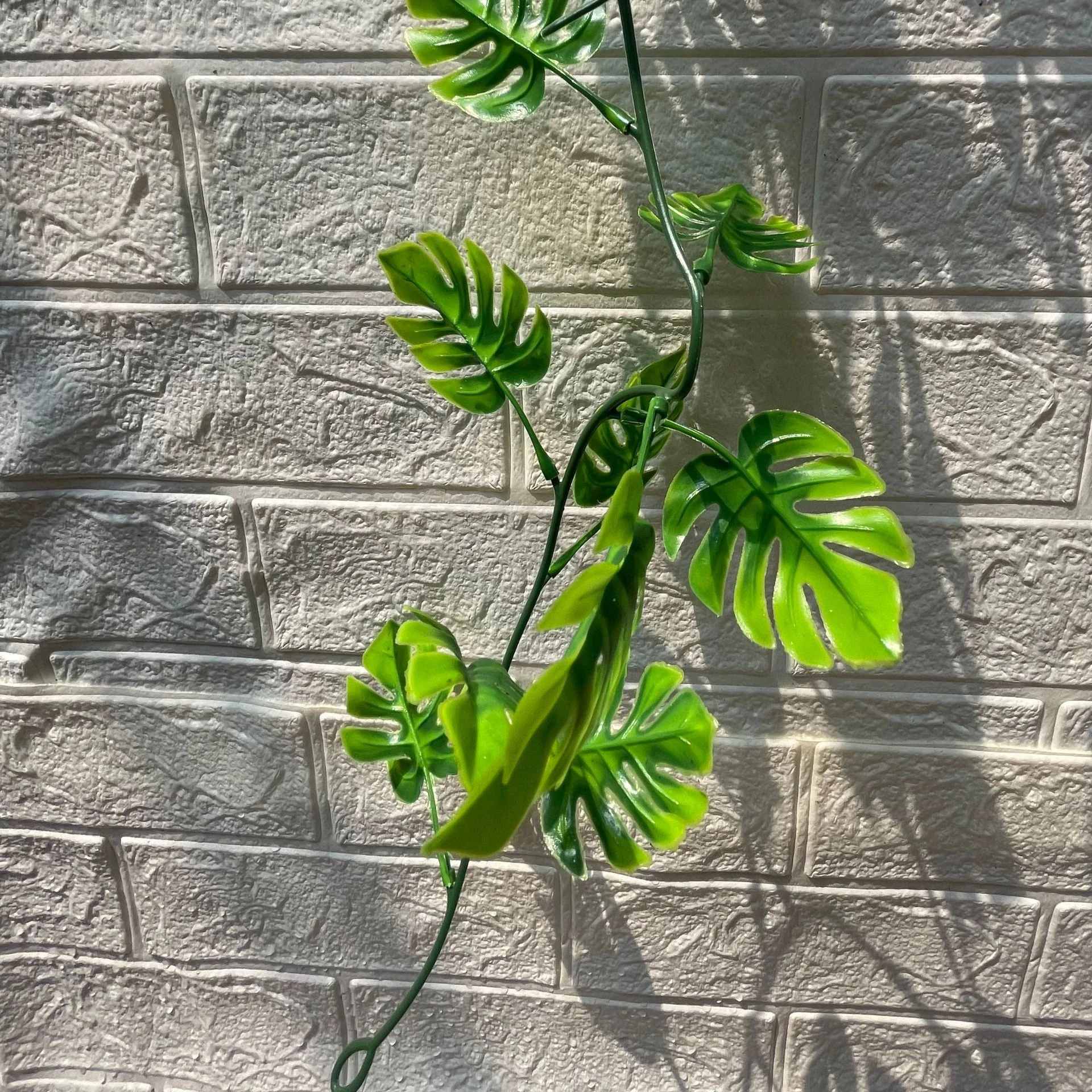 Close-up of leaves on artificial monstera garland