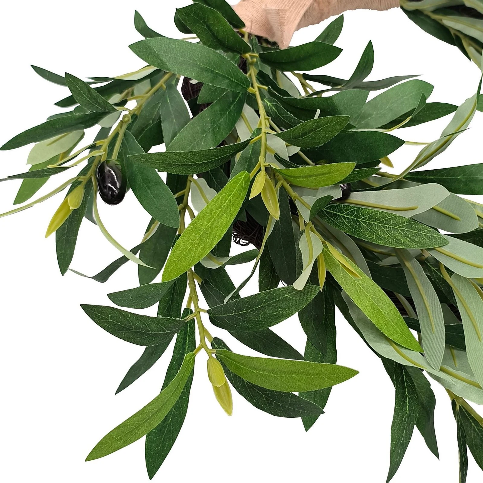 Close-up of layered artificial olive leaves and fruit accents
