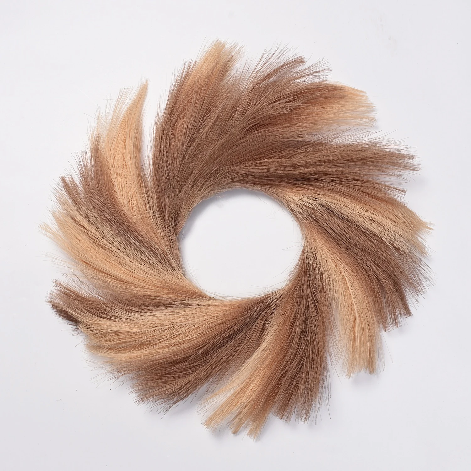 Brown artificial pampas grass wreath on a white background