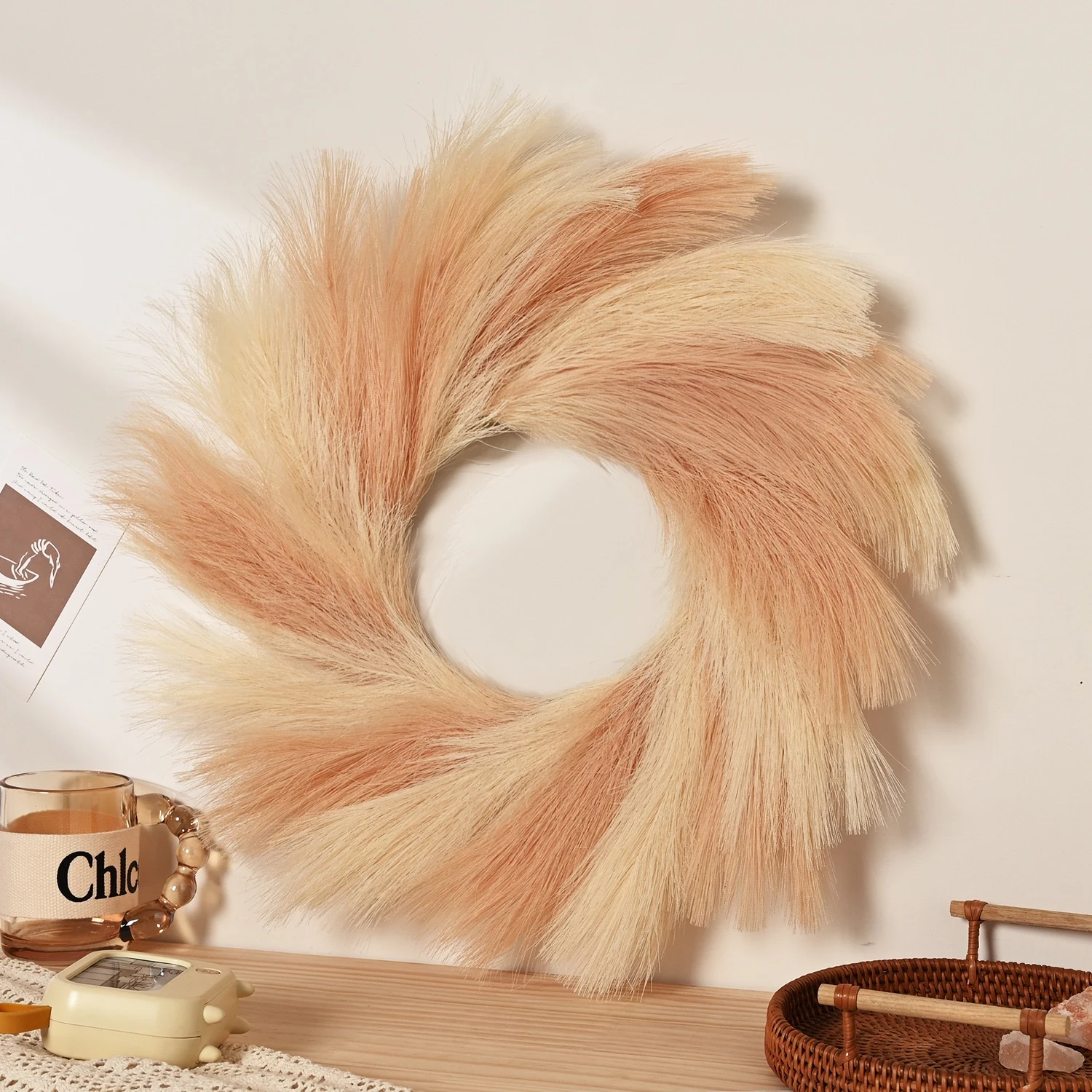 Peach artificial pampas grass wreath in a styled home display