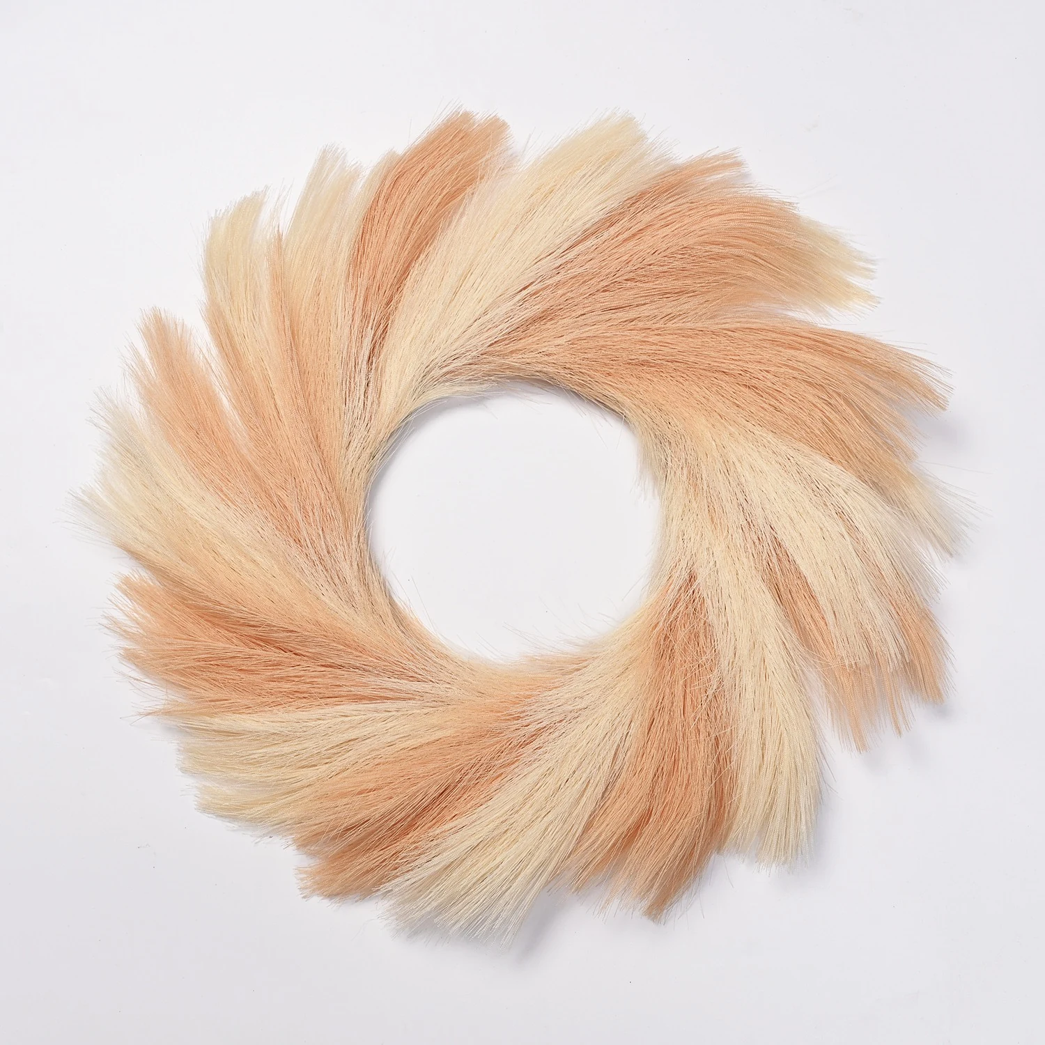 Peach artificial pampas grass wreath on a white background