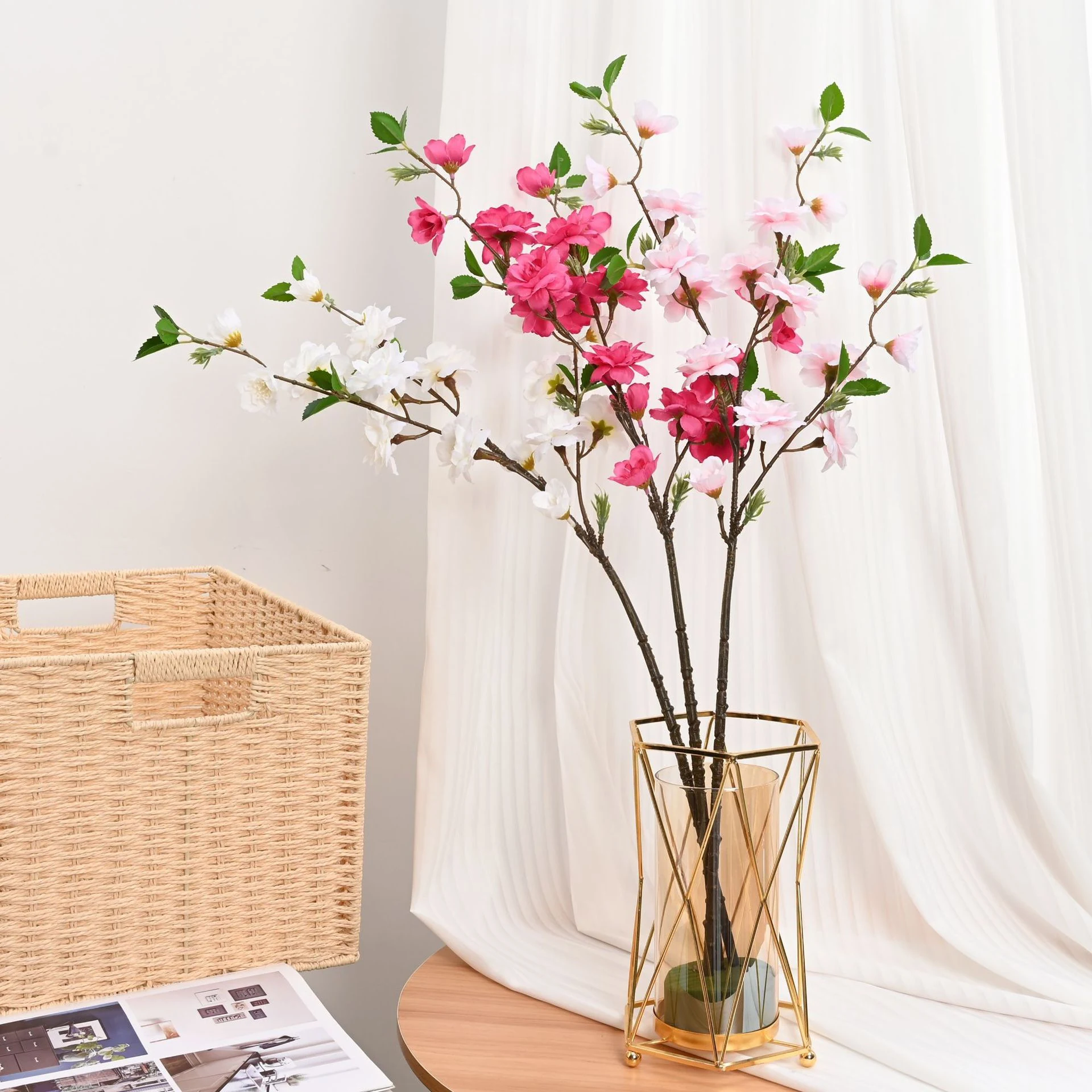 Rose pink, light pink and white artificial peach blossom branches in a vase