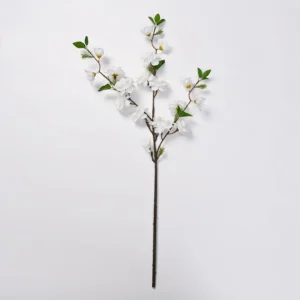 White artificial peach blossom branch on a white background