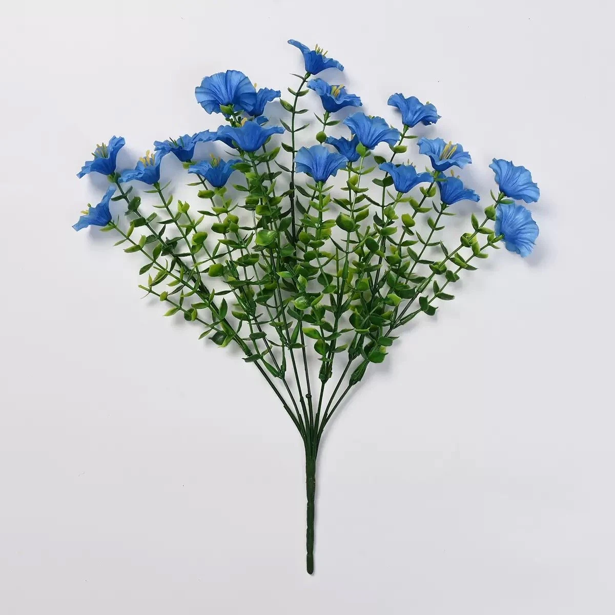 Blue artificial petunia flower bush on a white background