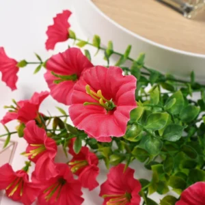 Close-up of hot pink artificial petunia flowers and foliage