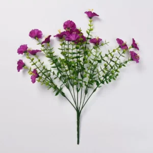 Magenta artificial petunia flower bush on a white background