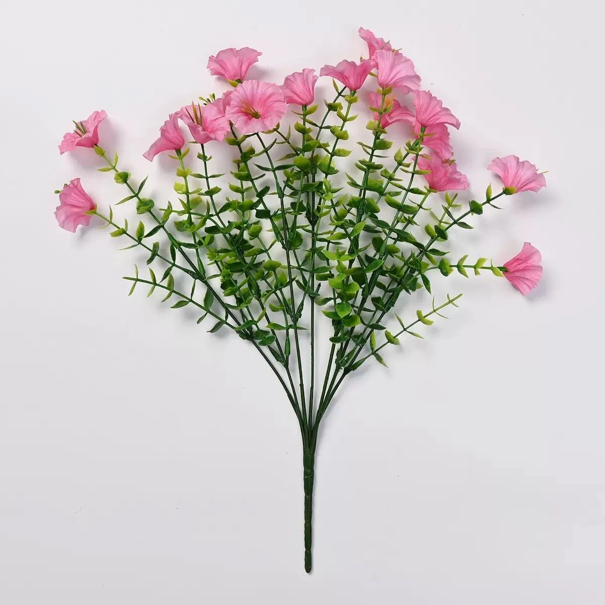 Pink artificial petunia flower bush on a white background