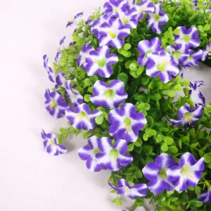 Close-up of purple artificial petunia blooms and green foliage