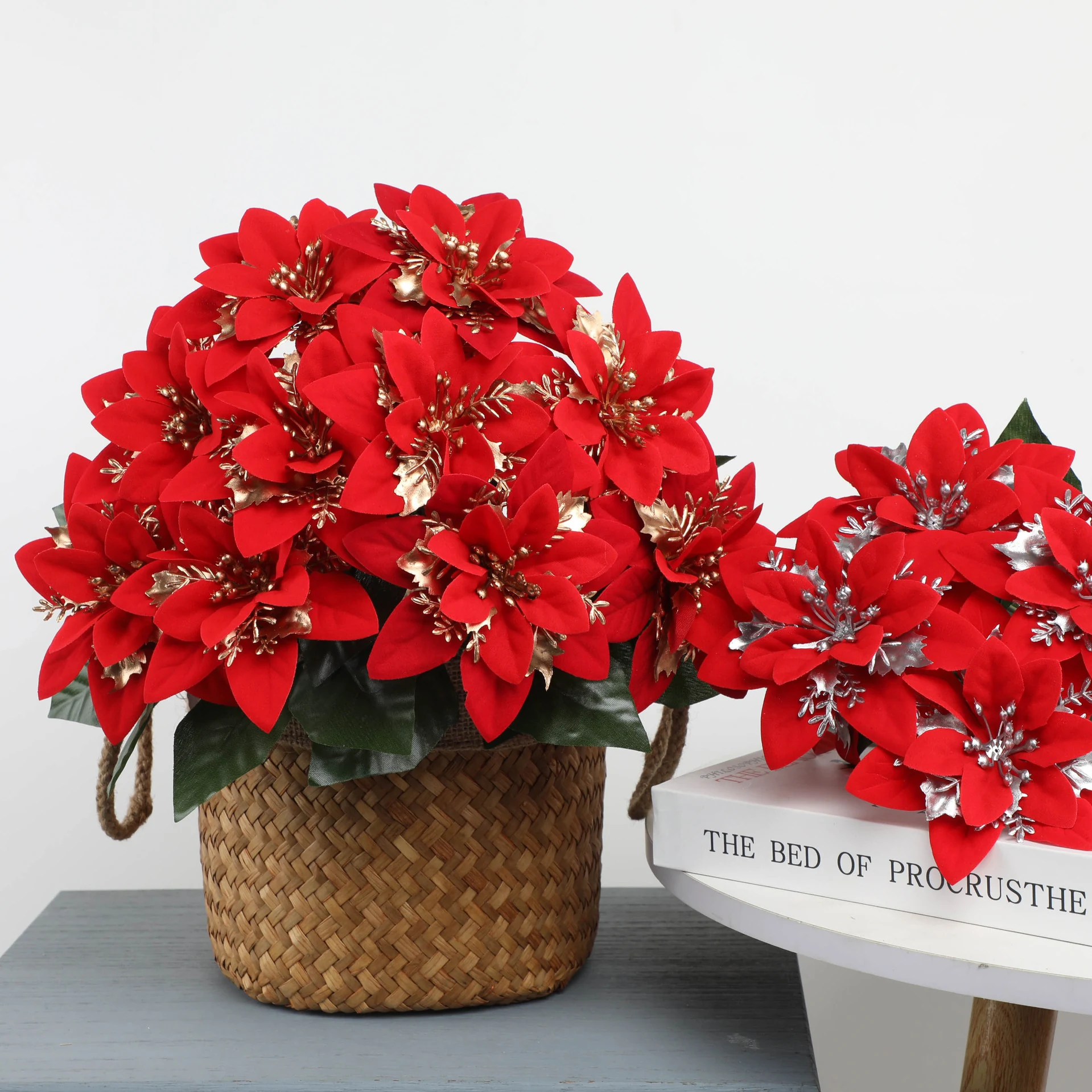 Artificial poinsettia flower bushes arranged in decorative planters