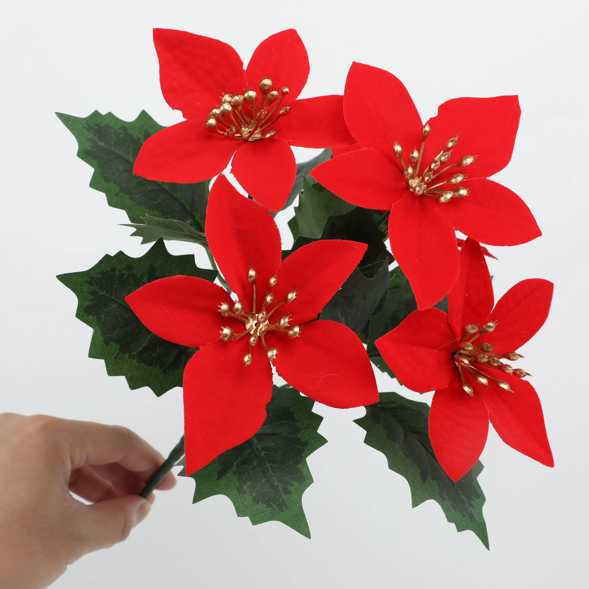 Close-up of red artificial poinsettia flowers with silver accents