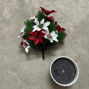 Artificial poinsettia pine bush shown beside a decorative pot