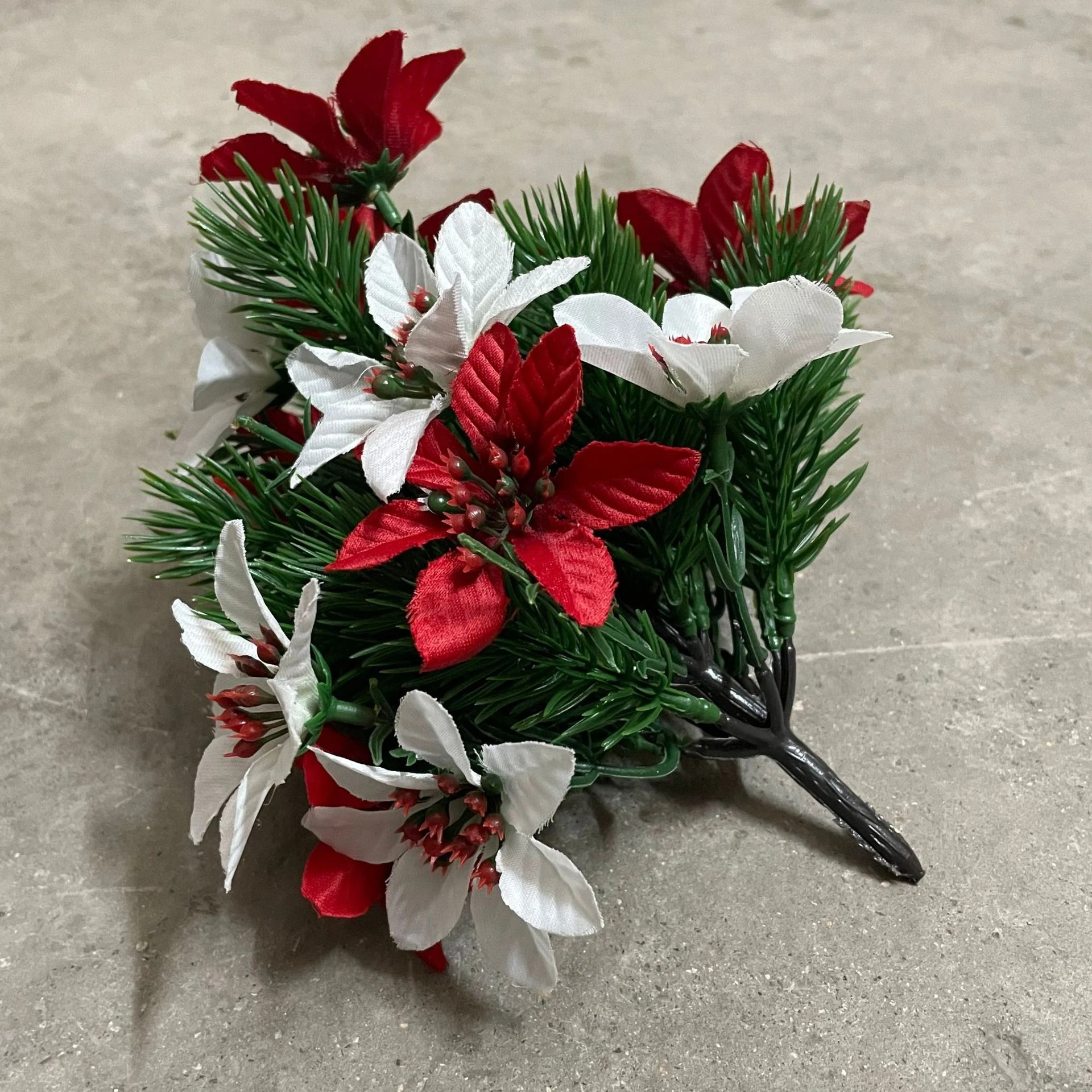 Unpotted artificial poinsettia pine bush showing its branching base