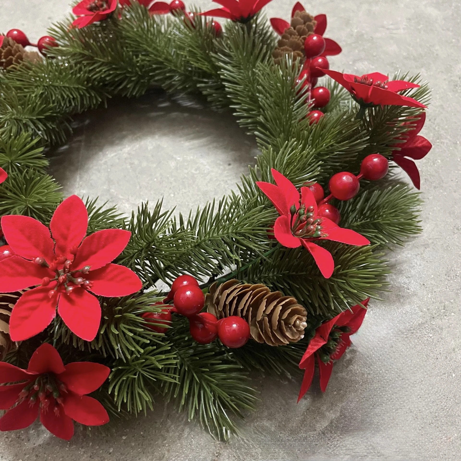 Close-up of detail artificial poinsettia pine christmas wreath