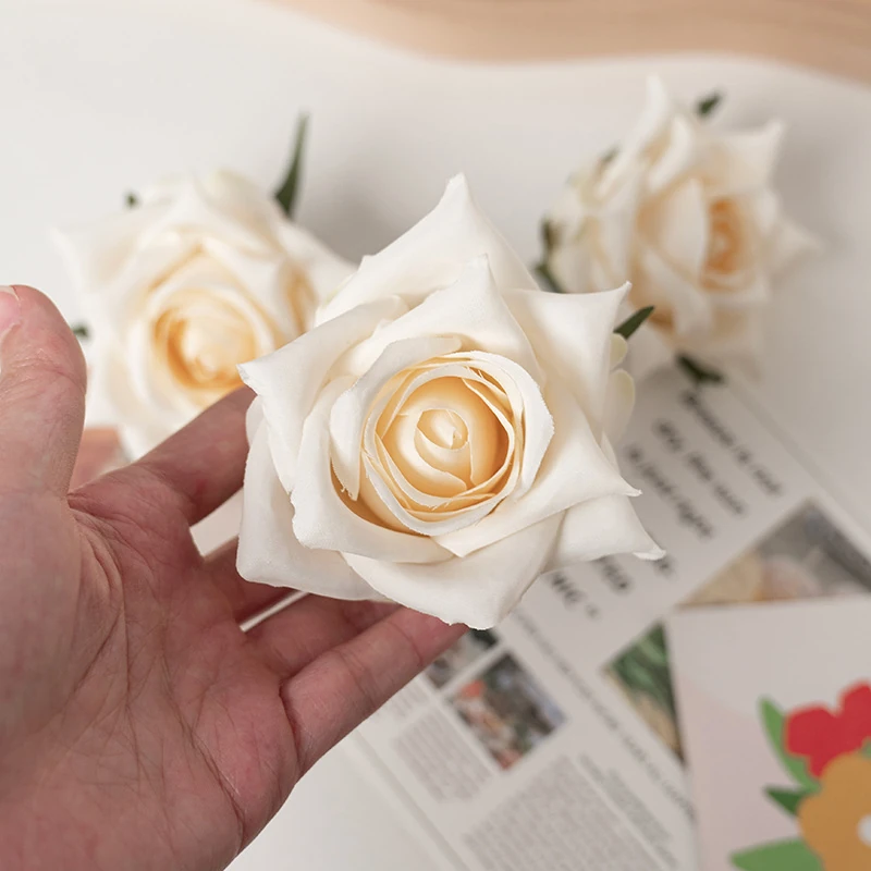 Hand-held detail of white artificial Pointed-Petal Rose Flower Head