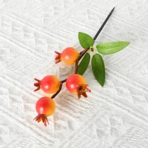 Close-up of artificial pomegranate fruit pick