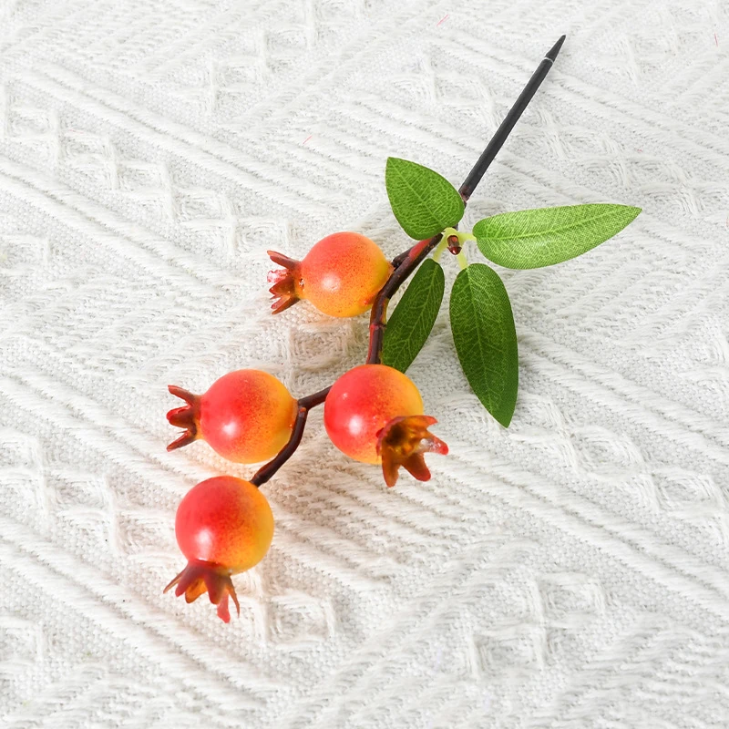 Close-up of artificial pomegranate fruit pick