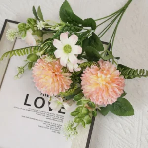 Champagne artificial pompon chrysanthemum mixed flower bouquet displayed flat on a book