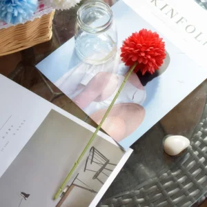 Red artificial pompon mum stem in a styled tabletop display