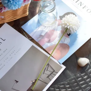 White artificial single-head pompon mum stem in a styled tabletop display