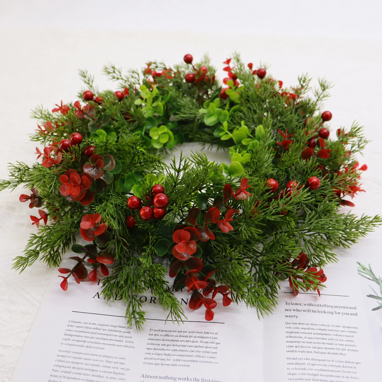 Artificial Red Berry Mixed Greenery Wreath arranged for decorative display