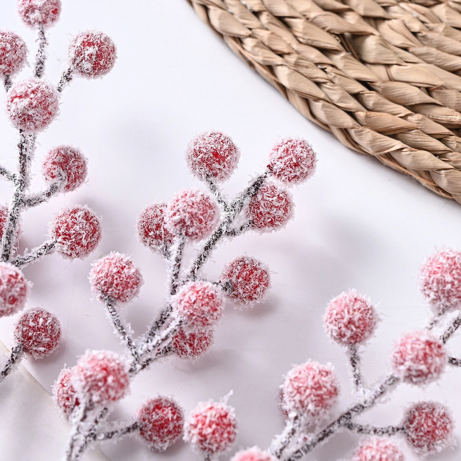 Close-up of snow-dusted red berries and flocked texture