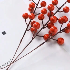 Multiple glossy red artificial berry picks shown together