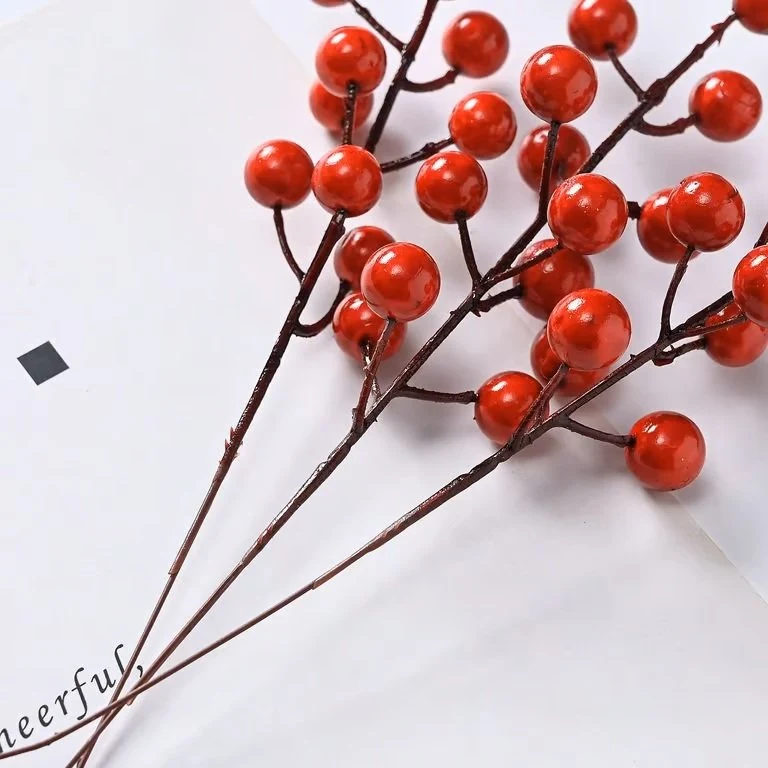 Multiple glossy red artificial berry picks shown together