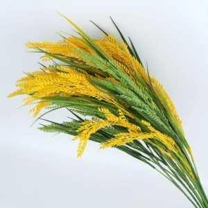 Bundle of golden artificial rice stems