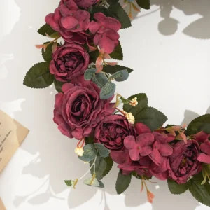 Close-up of red artificial roses and hydrangea flowers on wreath