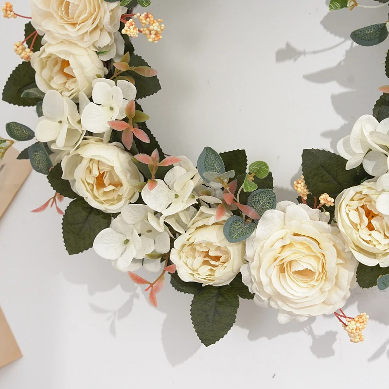 Close-up of white artificial roses and hydrangea flowers on wreath