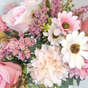 Close-up of blush pink artificial rose bouquet with pompon and daisy-like flowers