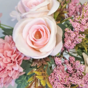 Close-up of blush pink artificial rose and pink filler sprigs
